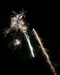 Low angle view of firework display at night