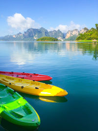 Boats moored in lake against sky