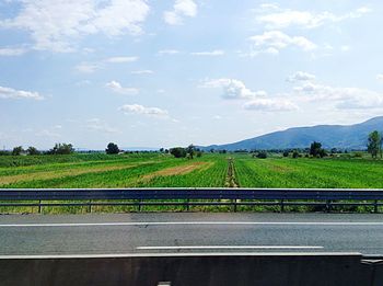 Road passing through landscape against sky