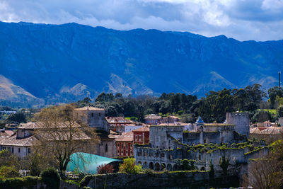 High angle view of townscape and mountains against sky