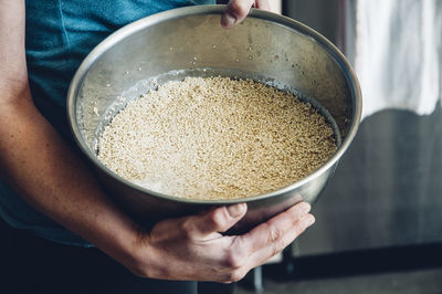 Midsection of woman carrying food in container