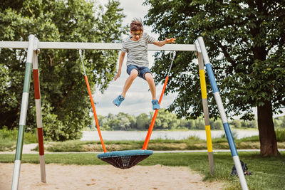 Full length of boy playing at playground