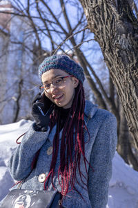 Portrait of young woman standing outdoors