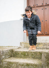 Portrait of boy standing by fountain