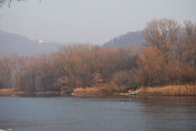 Scenic view of lake against sky during winter