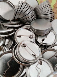 Full frame shot of metal lids with plates on table