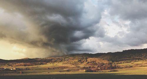 Scenic view of landscape against dramatic sky