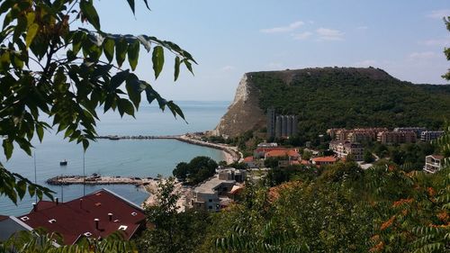 High angle view of houses by sea against sky