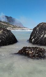 Scenic view of sea against clear blue sky