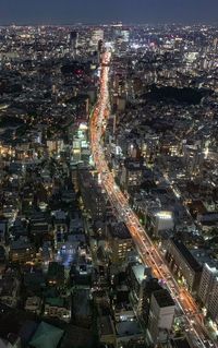 High angle view of city lit up at night