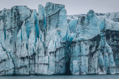 Rock formations in sea against sky