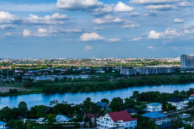 High angle view of river by buildings against sky