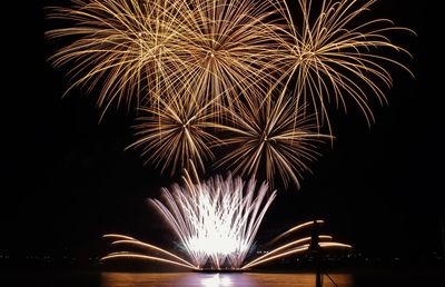 Low angle view of firework display at night