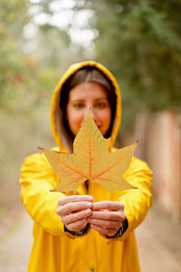 Young woman holding red flower