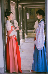 Young woman looking at camera while standing outdoors