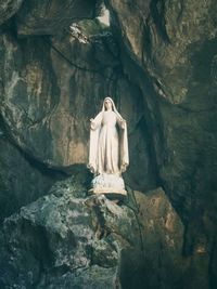 Low angle view of statue against rock formation