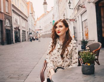 Portrait of woman on street in city