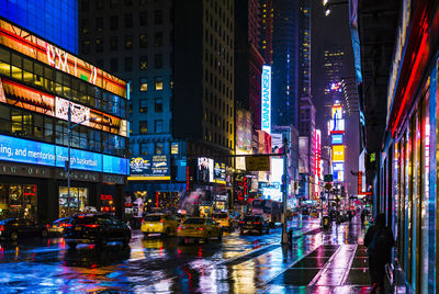 Illuminated city street at night