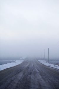 Road passing through foggy weather