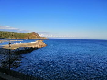 Scenic view of sea against clear blue sky