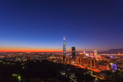 High angle view of city lit up at night