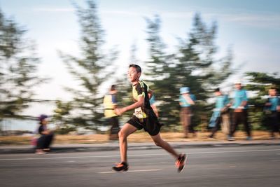 Full length of woman running on road