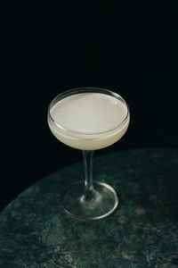 High angle view of wineglass on table against black background