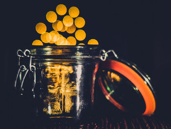 Close-up of illuminated lights against black background