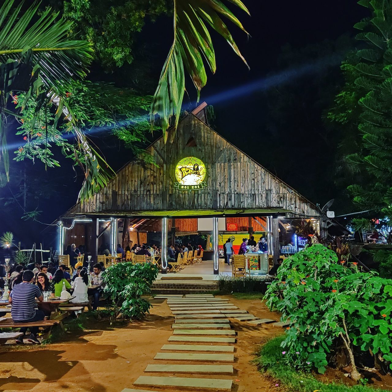 PEOPLE ON ILLUMINATED BUILDING AT NIGHT