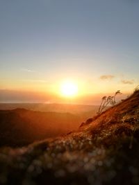 Scenic view of land against sky during sunset