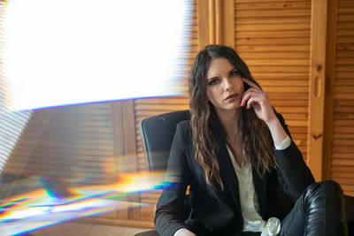 Portrait of businesswoman sitting on seat at office