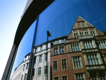 Low angle view of buildings against blue sky