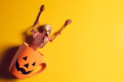 Close-up of a boy against yellow background