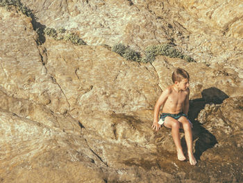 Full length of woman standing on rock