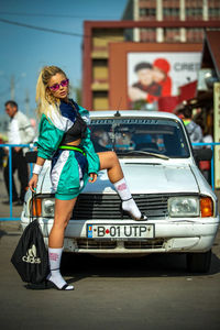 Woman standing in a car