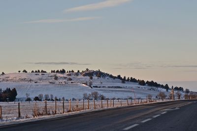 Panoramic view of road against sky during winter
