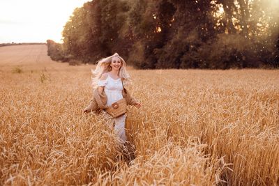 Rear view of woman standing on field