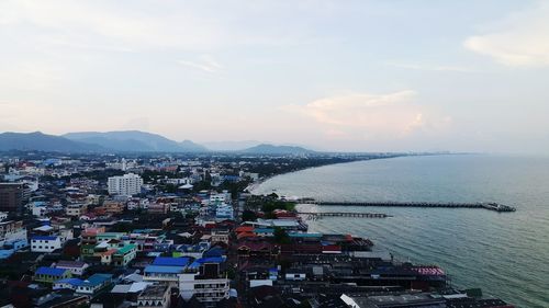 High angle view of buildings by sea against sky