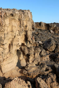 Rock formation on land against sky