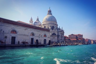 Santa maria della salute by grand canal against blue sky