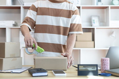 Midsection of man working in office