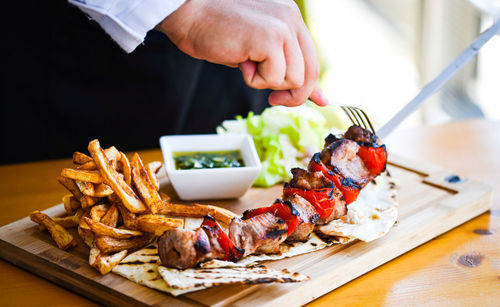 Close-up of person preparing food on table