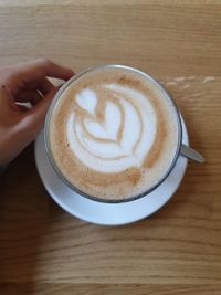 Midsection of coffee cup on table