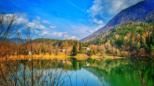 Scenic view of lake by trees against sky