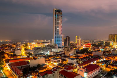 Illuminated cityscape against sky at night