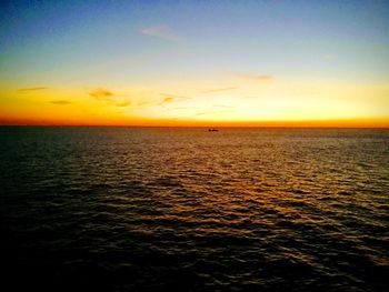 Scenic view of sea against romantic sky at sunset