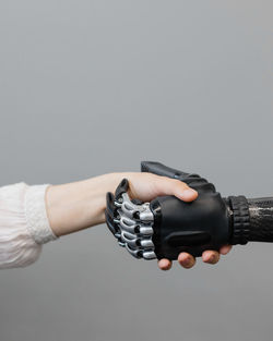 The human hand and the cyber hand bionic prosthesis make a handshake and greeting