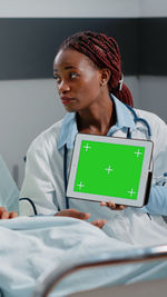 Doctor showing digital tablet in hospital