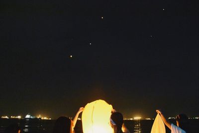People in illuminated city at night