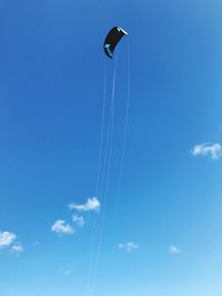 Low angle view of vapor trail against blue sky